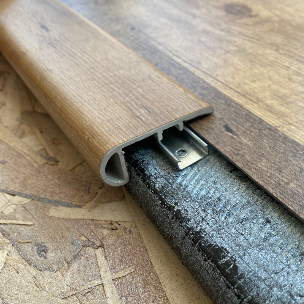 Close-up view of stair nose trim to finish the slideout flooring