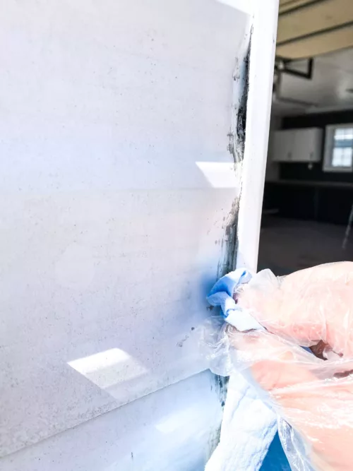 Hand applying acetone to clear an RV seam