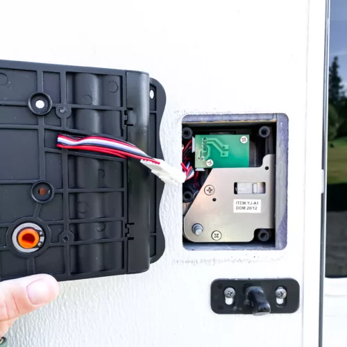 View of the wires of the keyless door lock being installed in an RV door