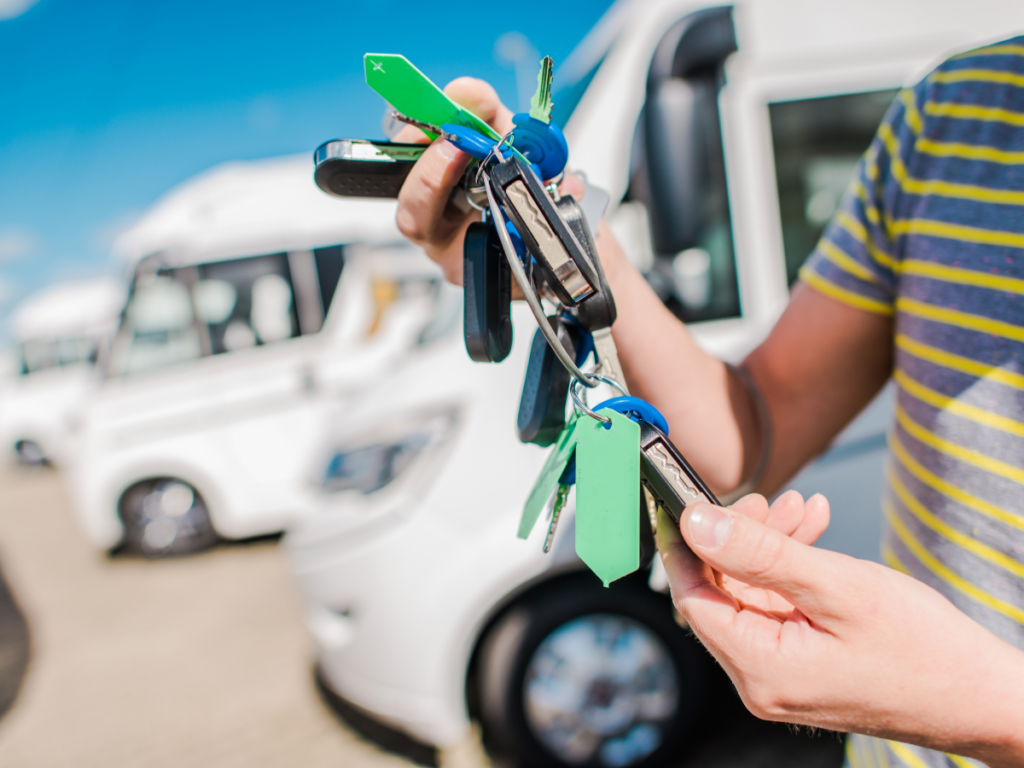 An RV salesman looks through his collection of camper keys.